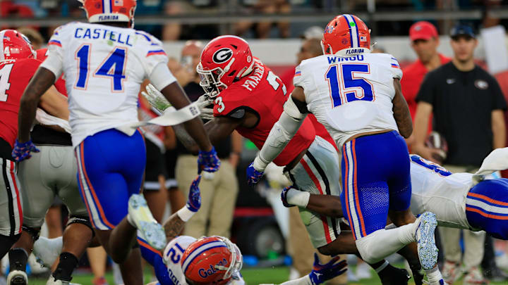 Georgia Bulldogs running back Nate Frazier (3) scores a touchdown as Florida Gators defensive back DJ Douglas (12), bottom, and linebacker Shemar James (6), back, can’t make the stop during the third quarter of an NCAA college football matchup Saturday, Nov. 2, 2024 at EverBank Stadium in Jacksonville, Fla. The Georgia Bulldogs defeated the Florida Gators 34-20. [Corey Perrine/Florida Times-Union]