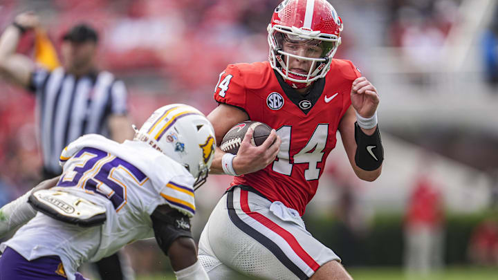 Sep 7, 2024; Athens, Georgia, USA; Georgia Bulldogs quarterback Gunner Stockton (14) runs against Tennessee Tech Golden Eagles defensive back Eric Taylor (35) during the second half at Sanford Stadium. Mandatory Credit: Dale Zanine-Imagn Images Sep 7, 2024; Athens, Georgia, USA; Georgia Bulldogs quarterback Gunner Stockton (14) runs against Tennessee Tech Golden Eagles defensive back Eric Taylor (35) during the second half at Sanford Stadium. Mandatory Credit: Dale Zanine-Imagn Images