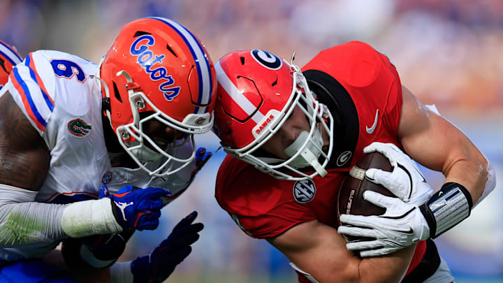 Florida Gators linebacker Shemar James (6) tackles Georgia Bulldogs tight end Oscar Delp (4) during the first quarter of an NCAA college football matchup Saturday, Nov. 2, 2024 at EverBank Stadium in Jacksonville, Fla. The Georgia Bulldogs defeated the Florida Gators 34-20. [Corey Perrine/Florida Times-Union]