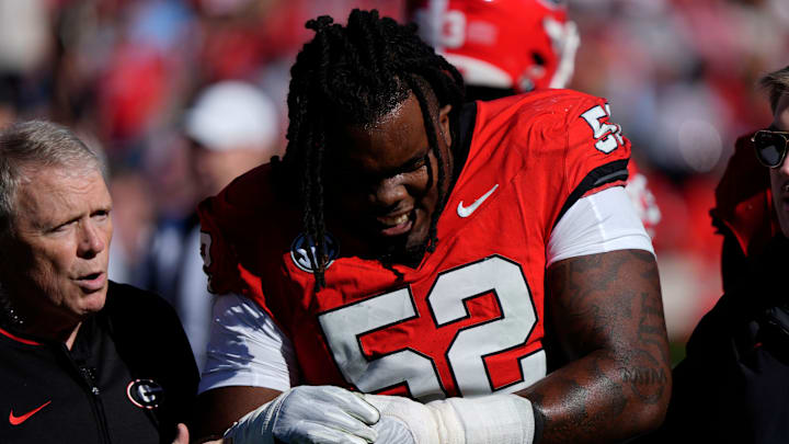 Georgia defensive lineman Christen Miller (52) leaves the field with an injury during the first half of a NCAA college football game against Massachusetts in Athens, Ga., on Saturday, Nov. 23, 2024. Georgia defensive lineman Christen Miller (52) leaves the field with an injury during the first half of a NCAA college football game against Massachusetts in Athens, Ga., on Saturday, Nov. 23, 2024.