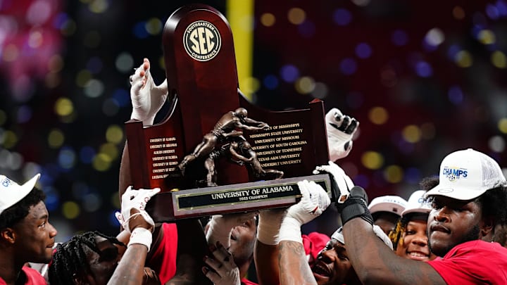 Dec 2, 2023; Atlanta, GA, USA; The Alabama Crimson Tide celebrate with the SEC championship trophy after defeating the Georgia Bulldogs at Mercedes-Benz Stadium. Mandatory Credit: John David Mercer-Imagn Images