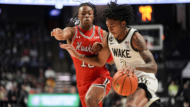 Nov 28, 2025; Winston-Salem, North Carolina, USA;  Wake Forest Demon Deacons guard Juke Harris (2) drives to the basket against Northeastern Huskies guard Miles Newton (10) during the first half at Lawrence Joel Veterans Memorial Coliseum. Mandatory Credit: Jim Dedmon-Imagn Images