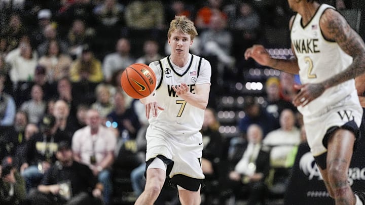 Feb 28, 2026; Winston-Salem, North Carolina, USA; Wake Forest Demon Deacons guard Isaac Carr (7) passes the ball to forward Juke Harris (2) during the first half against the Syracuse Orange at Lawrence Joel Veterans Memorial Coliseum. Mandatory Credit: Jim Dedmon-Imagn Images