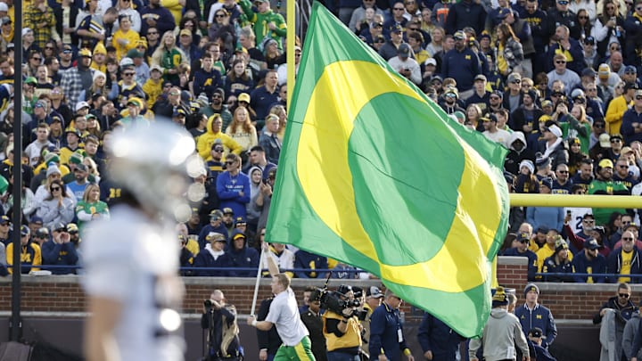 Nov 2, 2024; Ann Arbor, Michigan, USA;  Oregon Ducks cheerleader celebrates a touchdown in the first half against the Michigan Wolverines at Michigan Stadium. Mandatory Credit: Rick Osentoski-Imagn Images