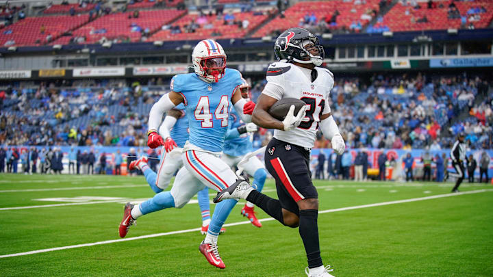 Houston Texans running back Dameon Pierce (31) runs in a touchdown past Tennessee Titans safety Mike Brown (44) during the second quarter at Nissan Stadium in Nashville, Tenn., Sunday, Jan. 5, 2025. Houston Texans running back Dameon Pierce (31) runs in a touchdown past Tennessee Titans safety Mike Brown (44) during the second quarter at Nissan Stadium in Nashville, Tenn., Sunday, Jan. 5, 2025.