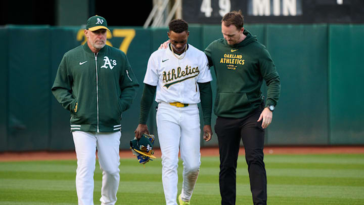 May 4, 2024; Oakland, California, USA; Oakland Athletics outfielder Esteury Ruiz (1) walks off the field with manager Mark Kotsay (7) (left) and head athletic trainer Jeffrey Collins after an injury during the sixth inning against the Miami Marlins at Oakland-Alameda County Coliseum.