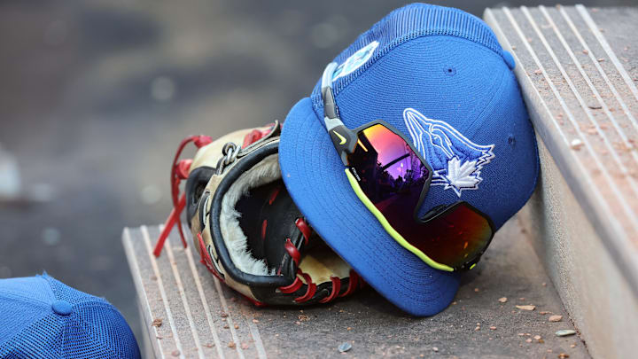A detail view of Toronto Blue Jays hat and glove against the Detroit Tigers at TD Ballpark. 