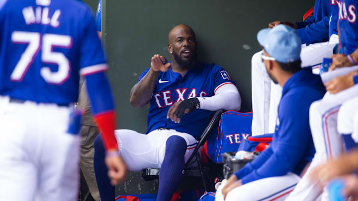 Surprise, Arizona, USA; Texas Rangers outfielder Adolis Garcia talks to teammates in the dugout against the Seattle Mariners during a spring training baseball game at Surprise Stadium.