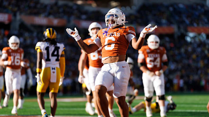 Dec 31, 2025; Orlando, FL, USA; Texas Longhorns running back Christian Clark (6) gestures after scoring a touchdown against the Michigan Wolverines during the first half at Camping World Stadium. Mandatory Credit: Matt Pendleton-Imagn Images
