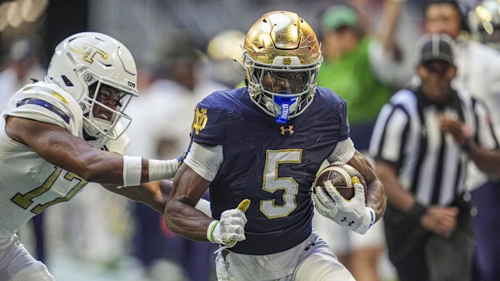 Oct 19, 2024; Atlanta, Georgia, USA; Notre Dame Fighting wide receiver Beaux Collins (5) runs against Georgia Tech Yellow Jackets linebacker Jackson Hamilton (17) during the first half at Mercedes-Benz Stadium. Oct 19, 2024; Atlanta, Georgia, USA; Notre Dame Fighting wide receiver Beaux Collins (5) runs against Georgia Tech Yellow Jackets linebacker Jackson Hamilton (17) during the first half at Mercedes-Benz Stadium.