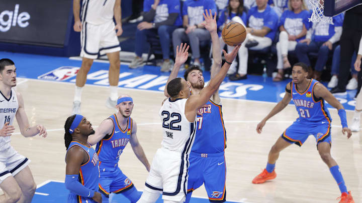 Memphis Grizzlies guard Desmond Bane (22) shoots as Oklahoma City Thunder forward Chet Holmgren (7) defends in the second quarter during game two of first round for the 2024 NBA Playoffs at Paycom Center. Memphis Grizzlies guard Desmond Bane (22) shoots as Oklahoma City Thunder forward Chet Holmgren (7) defends in the second quarter during game two of first round for the 2024 NBA Playoffs at Paycom Center.