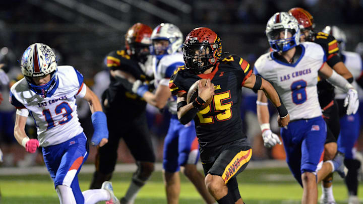 Rudy Rios carries the ball for the Hawks on one of his many successful attempts as the Centennial Hawks took on the Las Cruces High Bulldawgs on Friday night at Field of Dreams. Rudy Rios carries the ball for the Hawks on one of his many successful attempts as the Centennial Hawks took on the Las Cruces High Bulldawgs on Friday night at Field of Dreams.