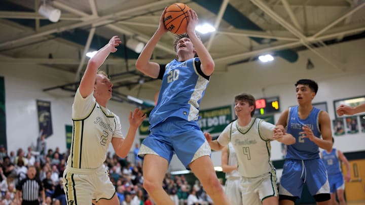 Ponte Vedra's Trace Westercamp (20) drives to the basket against Nease's Zach Buttacavoli (2) during the first quarter of a regular season high school basketball matchup Friday, Feb. 2, 2024 at Nease High School in Ponte Vedra Beach, Fla. The Ponte Vedra Sharks defeated the Nease Panthers 52-46. [Corey Perrine/Florida Times-Union]