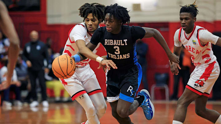 Ribault's Kaden Toure (3) dribbles past Jackson's Terrell Mosely (0) during the first quarter of the Gateway Conference high school boys basketball tournament final Friday, Jan. 24, 2025 at Jackson High School in Jacksonville, Fla. [Corey Perrine/Florida Times-Union]