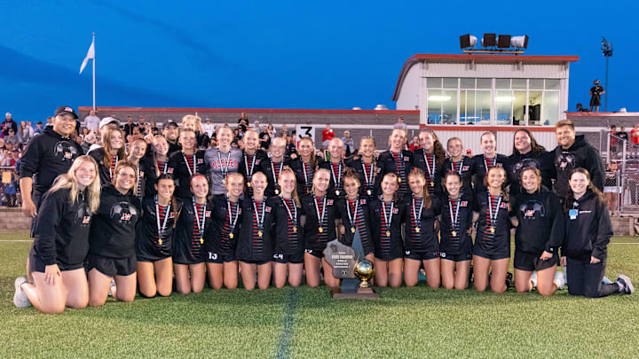 Muskego players and staff pose with the gold trophy ball after winning the WIAA Division 1 girls state soccer championship at Uihlein Soccer Park in Milwaukee, Saturday, June 15, 2024.