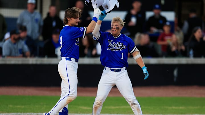 Trinity Christian's Gage Petrutz (1) taps helmets with Trinity Christian's Parker Loew (9) after a solo home run during the third inning of a high school baseball matchup Thursday, March 20, 2025 at Trinity Christian Academy in Jacksonville, Fla. The duo have helped their team move up to No. 7 on our latest rankings and in the semifinals of the Florida Class 2A Playoffs.