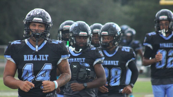 Ribault's Jayden Anderson (44) and teammates run through warm-ups before a high school football game at Raines on October 5, 2024. [Clayton Freeman/Florida Times-Union]