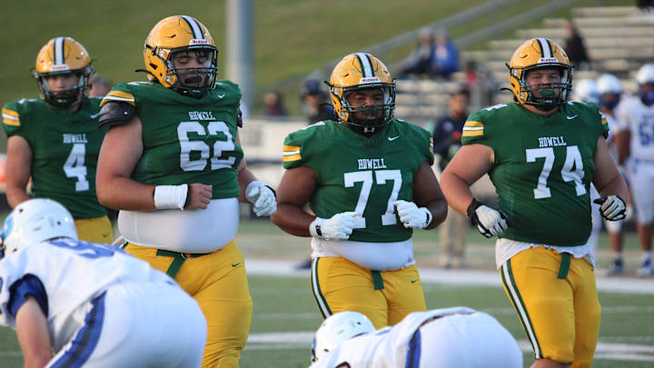 Howell offensive linemen Nate Rogowski (62), Landon Joiner (77) and Mason Schumaker (74) prepare for a play near the goal line against Salem on Friday, Sept. 5, 2025.