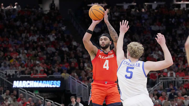 Illinois guard Kylan Boswell (4) hits a three-point basket over Kentucky guard Collin Chandler (5) during the second half of their second round NCAA men’ s basketball tournament game Sunday, March 23, 2025 at Fiserv Forum in Milwaukee, Wisconsin. Kentucky beat Illinois 84-75.