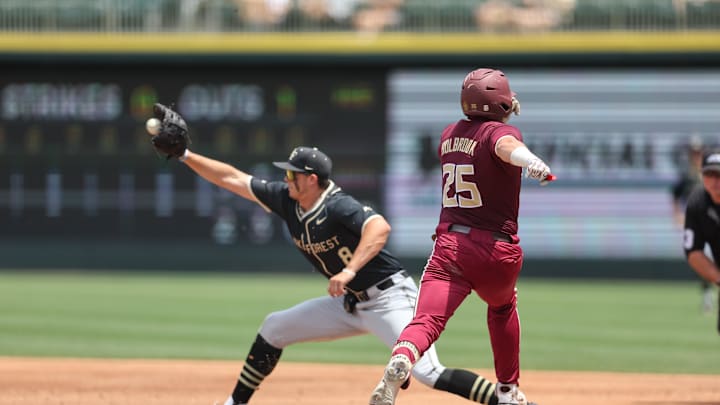 May 25, 2024; Charlotte, NC, USA; Florida State catcher McGwire Holbrook (25) gets out at first base by Wake Forest first baseman Nick Kurtz (8) in the second inning during the ACC Baseball Tournament at Truist Field. Mandatory Credit: Cory Knowlton-Imagn Images