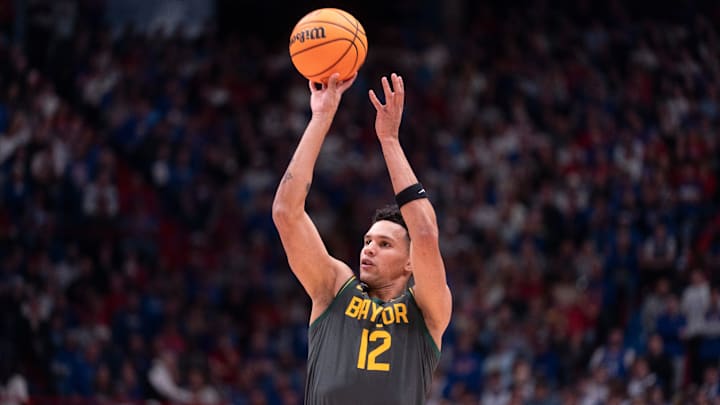 Baylor Bears guard Michael Rataj (12) shoots a three-pointer against Kansas Jayhawks during the game inside Allen Fieldhouse on Jan. 16, 2026. Baylor Bears guard Michael Rataj (12) shoots a three-pointer against Kansas Jayhawks during the game inside Allen Fieldhouse on Jan. 16, 2026.
