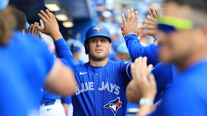 Daulton Varsho high fives teammates. 