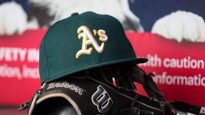 Jun 1, 2024; Atlanta, Georgia, USA; A detailed view of an Oakland Athletics hat and glove on the field against the Atlanta Braves in the sixth inning at Truist Park. Mandatory Credit: Brett Davis-Imagn Images
