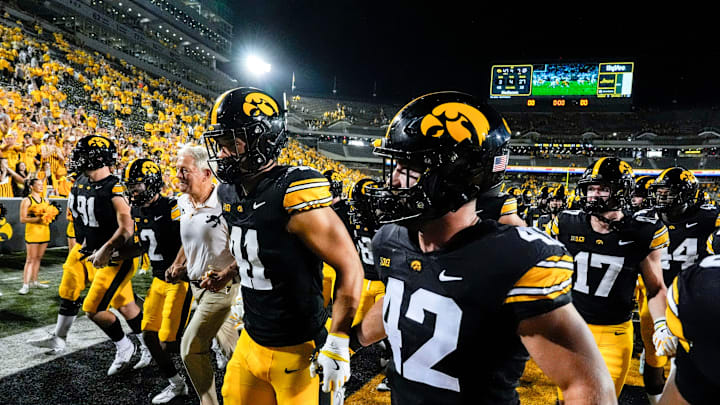Iowa Hawkeyes head coach Kirk Ferentz runs off the field with his players after becoming the winningest coach in Big Ten history, passing Woody Hayes, with a win over the Massachusetts Minutemen Sept. 13, 2025 at Kinnick Stadium in Iowa City, Iowa.