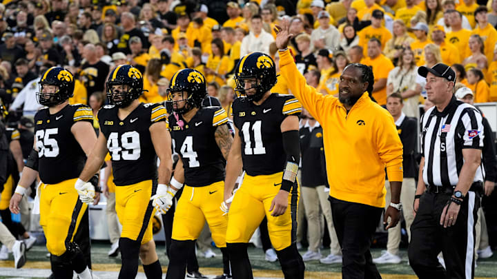 Iowa Hawkeyes captains walk to mid-field during a college football game against the Penn State Nittany Lions Oct. 18, 2025 at Kinnick Stadium in Iowa City, Iowa. Iowa Hawkeyes captains walk to mid-field during a college football game against the Penn State Nittany Lions Oct. 18, 2025 at Kinnick Stadium in Iowa City, Iowa.