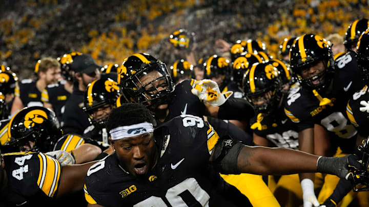 Iowa Hawkeyes defensive lineman Kenneth Merrieweather (44) and Iowa Hawkeyes defensive end Brian Allen (90) celebrate with their teammates after defeating the Penn State Nittany Lions 25-24 Oct. 18, 2025 at Kinnick Stadium in Iowa City, Iowa.