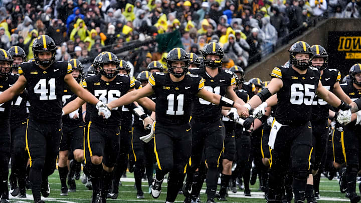 The Iowa Hawkeyes swarm onto the field Nov. 8, 2025 ahead of a Big Ten Football game against the Oregon Ducks at Kinnick Stadium in Iowa City, Iowa.