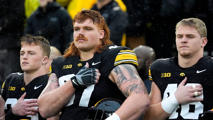Iowa Hawkeyes offensive lineman Gennings Dunker (67), center, stands with teammates for the national anthem Nov. 8, 2025 before a Big Ten Football game against the Oregon Ducks at Kinnick Stadium in Iowa City, Iowa.