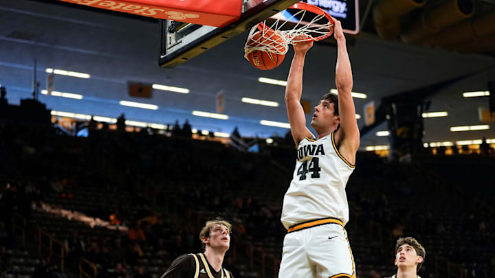 Iowa forward Joey Matteoni (44) dunks against Western Michigan forward Hudson Ward (8) and Western Michigan guard Nicholas Errica (9) Dec. 14, 2025 at Carver-Hawkeye Arena in Iowa City, Iowa.