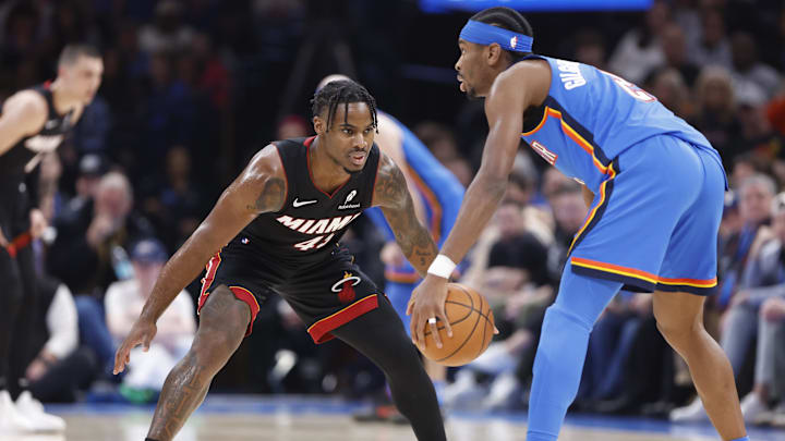 Feb 12, 2025; Oklahoma City, Oklahoma, USA; Miami Heat guard Davion Mitchell (45) defends Oklahoma City Thunder guard Shai Gilgeous-Alexander (2) as he dribbles down the court during the second quarter at Paycom Center. Mandatory Credit: Alonzo Adams-Imagn Images