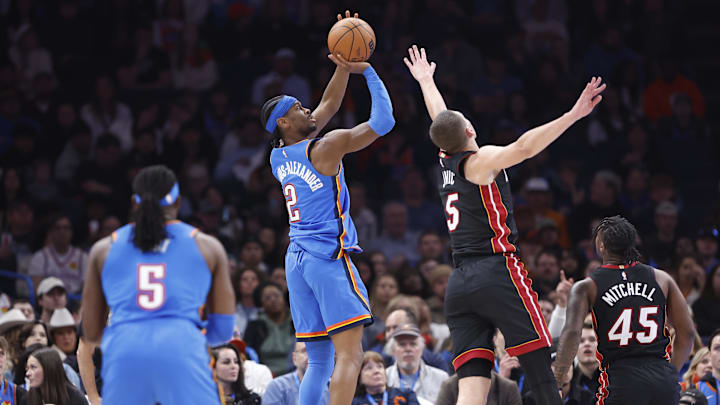 Feb 12, 2025; Oklahoma City, Oklahoma, USA; Oklahoma City Thunder guard Shai Gilgeous-Alexander (2) shoots as Miami Heat forward Nikola Jovic (5) defends during the second quarter at Paycom Center. Mandatory Credit: Alonzo Adams-Imagn Images