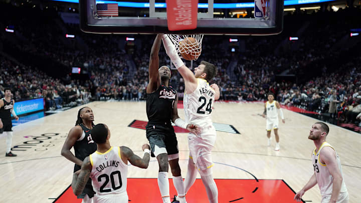 Dec 6, 2024; Portland, Oregon, USA; Portland Trail Blazers small forward Jerami Grant (9) dunks the ball over Utah Jazz center Walker Kessler (24) during the second half at Moda Center. Mandatory Credit: Soobum Im-Imagn Images