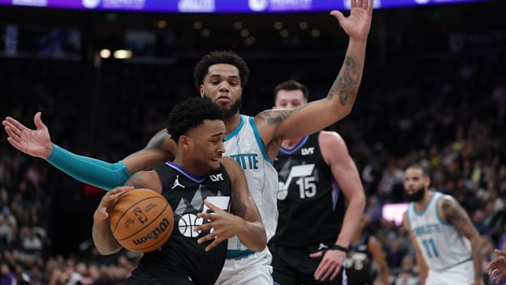 Jan 15, 2025; Salt Lake City, Utah, USA;  Utah Jazz forward Brice Sensabaugh (28) drives against Charlotte Hornets forward Miles Bridges (0) during the second half at Delta Center. Mandatory Credit: Chris Nicoll-Imagn Images