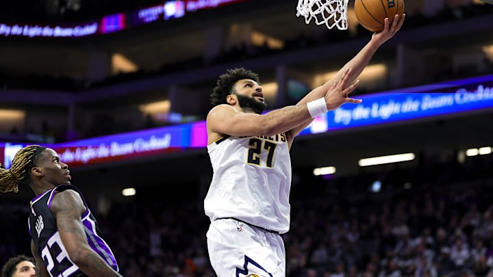 Dec 16, 2024; Sacramento, California, USA; Denver Nuggets guard Jamal Murray (27) drives to the basket against Sacramento Kings guard Keon Ellis (23) during the second quarter at Golden 1 Center. Mandatory Credit: Sergio Estrada-Imagn Images Dec 16, 2024; Sacramento, California, USA; Denver Nuggets guard Jamal Murray (27) drives to the basket against Sacramento Kings guard Keon Ellis (23) during the second quarter at Golden 1 Center. Mandatory Credit: Sergio Estrada-Imagn Images