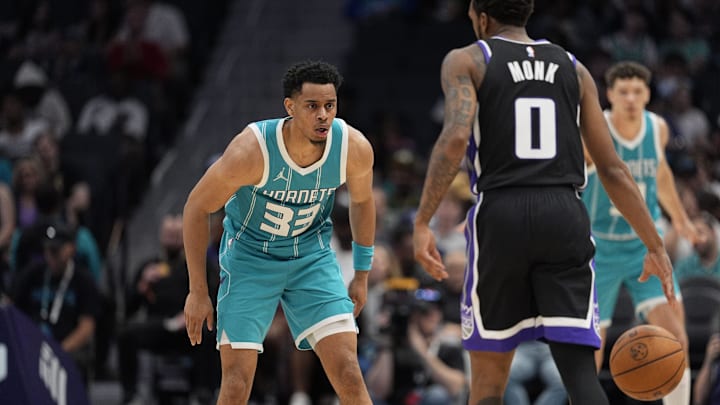 Apr 4, 2025; Charlotte, North Carolina, USA; Charlotte Hornets guard Jaylen Sims (33) on defense against Sacramento Kings guard Malik Monk (0) during the second half at Spectrum Center. Mandatory Credit: Jim Dedmon-Imagn Images