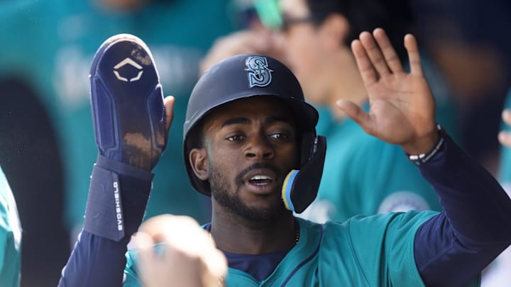 Seattle Mariners infielder Ryan Bliss celebrates with teammates in the dugout after scoring against the San Diego Padres during a spring training game at Peoria Sports Complex on March 15. Seattle Mariners infielder Ryan Bliss celebrates with teammates in the dugout after scoring against the San Diego Padres during a spring training game at Peoria Sports Complex on March 15.