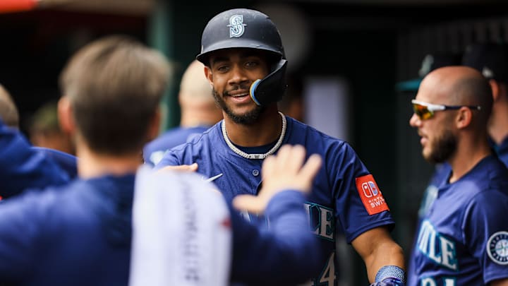 Seattle Mariners outfielder Julio Rodriguez (44) high fives teammates after scoring on a RBI single hit by catcher Cal Raleigh (not pictured) in the fifth inning against the Cincinnati Reds at Great American Ball Park on April 17.