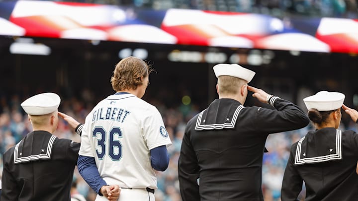 Seattle Mariners pitcher Logan Gilbert (36) stands with members of the Navy during the national anthem before a game against the Texas Rangers at T-Mobile Park on April 12.