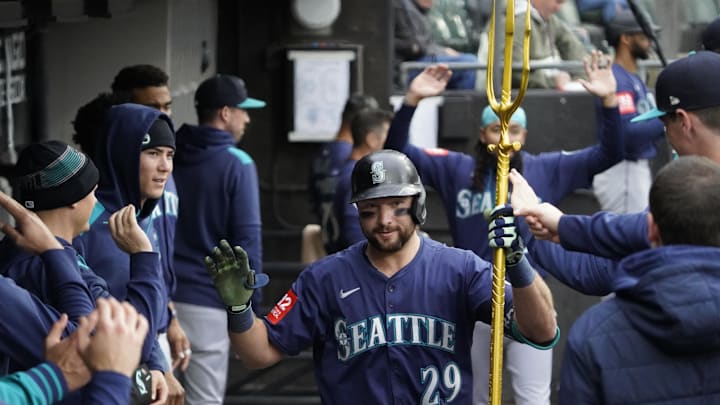 Seattle Mariners catcher Cal Raleigh (29) is greeted in the dugout after hitting a home run against the Chicago White Sox during the sixth inning at Rate Field on May 21.
