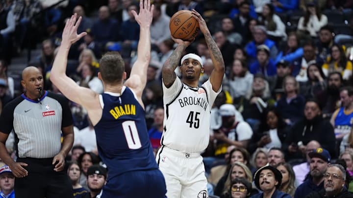 Jan 10, 2025; Denver, Colorado, USA; Brooklyn Nets guard Keon Johnson (45) shoots the ball over Denver Nuggets guard Christian Braun (0) in the second half at Ball Arena. Mandatory Credit: Ron Chenoy-Imagn Images