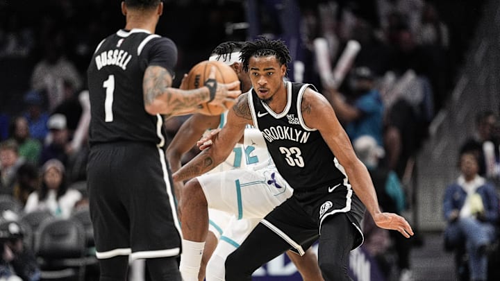 Jan 29, 2025; Charlotte, North Carolina, USA; Brooklyn Nets center Nic Claxton (33) waits for the pass from guard D'Angelo Russell (1) during the second half against the Charlotte Hornets at Spectrum Center. Mandatory Credit: Jim Dedmon-Imagn Images