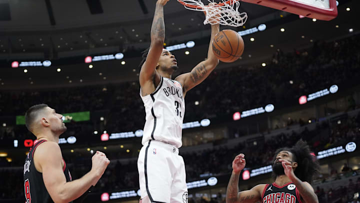 Mar 13, 2025; Chicago, Illinois, USA; Brooklyn Nets center Nic Claxton (33) dunks the ball on Chicago Bulls guard Coby White (0) during the second half at United Center. Mandatory Credit: David Banks-Imagn Images