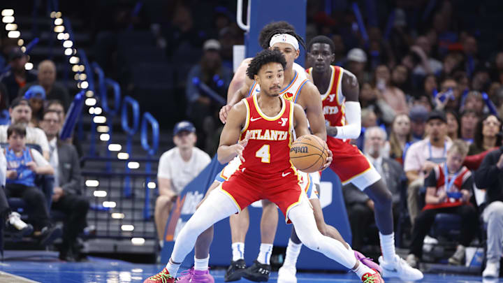 Oct 17, 2024; Oklahoma City, Oklahoma, USA; Atlanta Hawks guard Kobe Bufkin (4) moves the ball around Oklahoma City Thunder forward Ousmane Dieng (13) during the second half at Paycom Center. Mandatory Credit: Alonzo Adams-Imagn Images Oct 17, 2024; Oklahoma City, Oklahoma, USA; Atlanta Hawks guard Kobe Bufkin (4) moves the ball around Oklahoma City Thunder forward Ousmane Dieng (13) during the second half at Paycom Center. Mandatory Credit: Alonzo Adams-Imagn Images