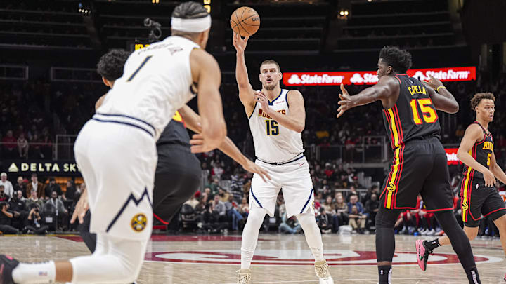 Denver Nuggets center Nikola Jokic (15) passes the ball against the Atlanta Hawks during the first half at State Farm Arena. Mandatory Credit: Dale Zanine-Imagn Images