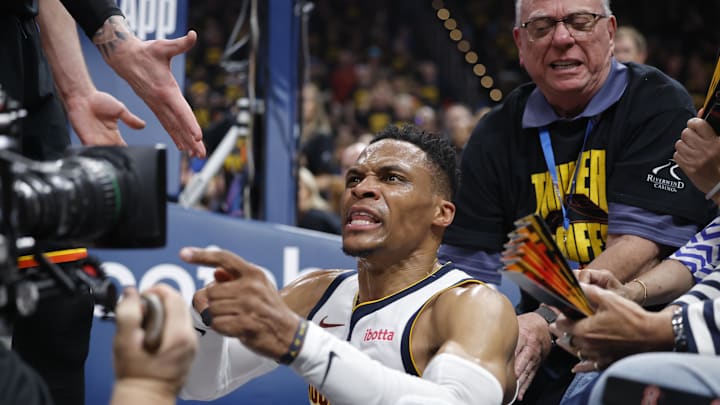 May 7, 2025; Oklahoma City, Oklahoma, USA; Denver Nuggets guard Russell Westbrook (4) reacts after a play and falling into fans in the second quarter against the Oklahoma City Thunder during game two of the second round for the 2025 NBA Playoffs at Paycom Center. Mandatory Credit: Alonzo Adams-Imagn Images