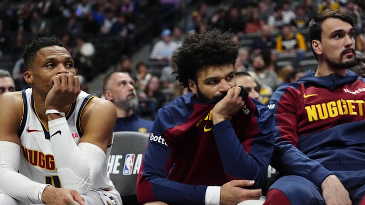 Mar 12, 2025; Denver, Colorado, USA; Denver Nuggets guard Russell Westbrook (4), guard Jamal Murray (27) and forward Dario Saric (9) on the bench in the fourth quarter against the Minnesota Timberwolves at Ball Arena. Mandatory Credit: Ron Chenoy-Imagn Images